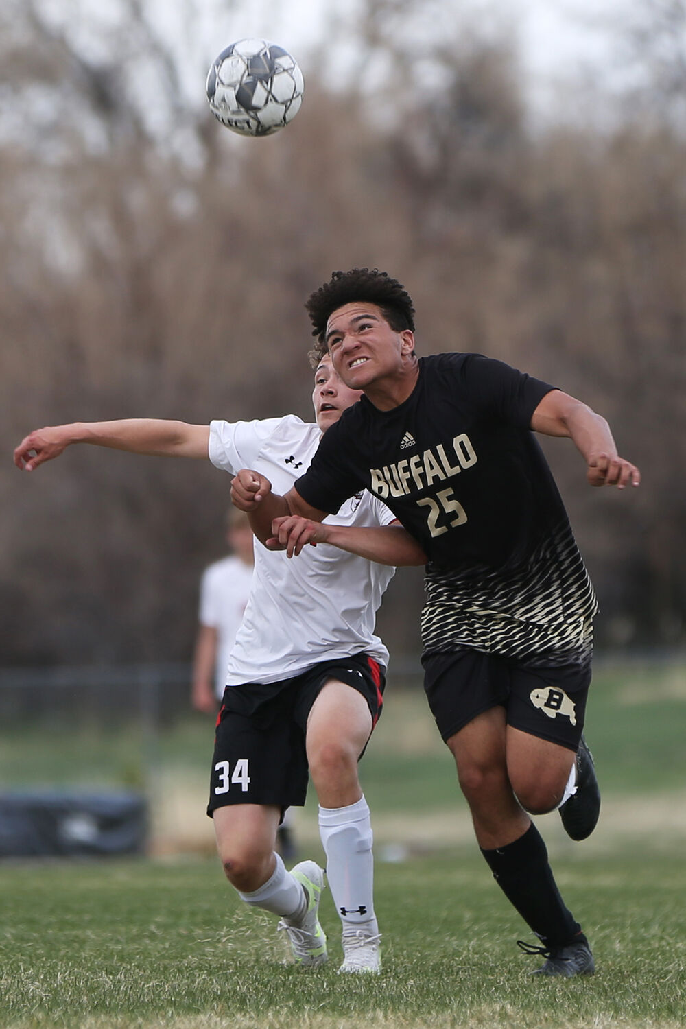Kadon Boyce dives forward to head the ball back into his possession